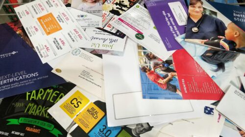 various direct mail pieces piled together