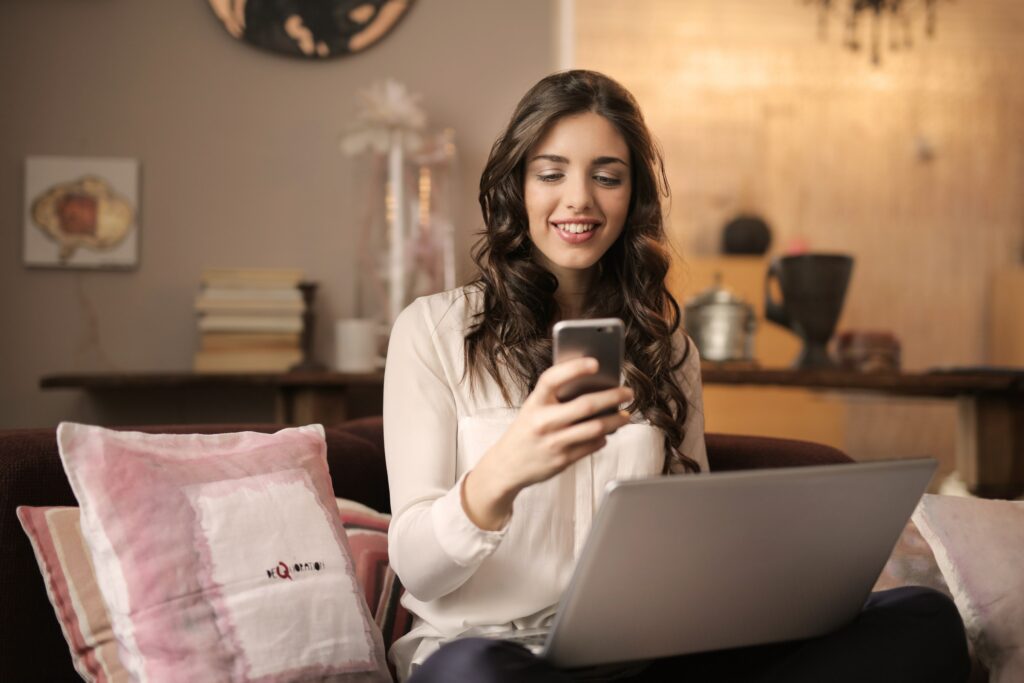 young woman looking at phone and researching professional direct mail services