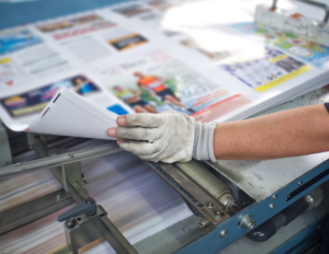 closeup of employees arm working on printing direct mail marketing resources